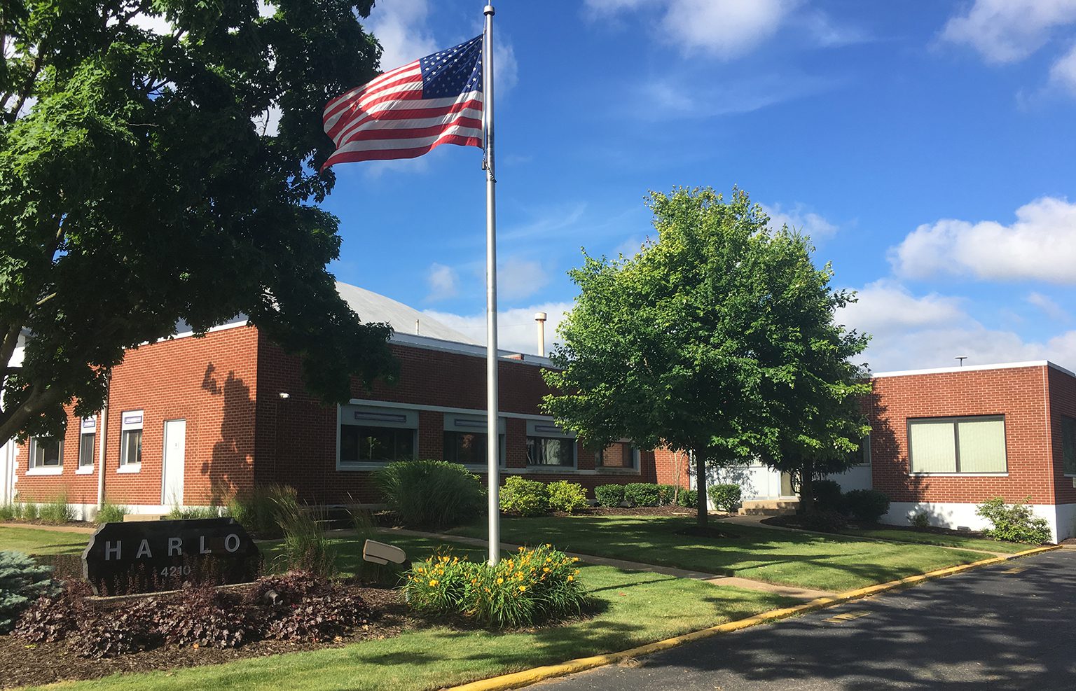 Exterior of Harlo's manufacturing facility with American flag