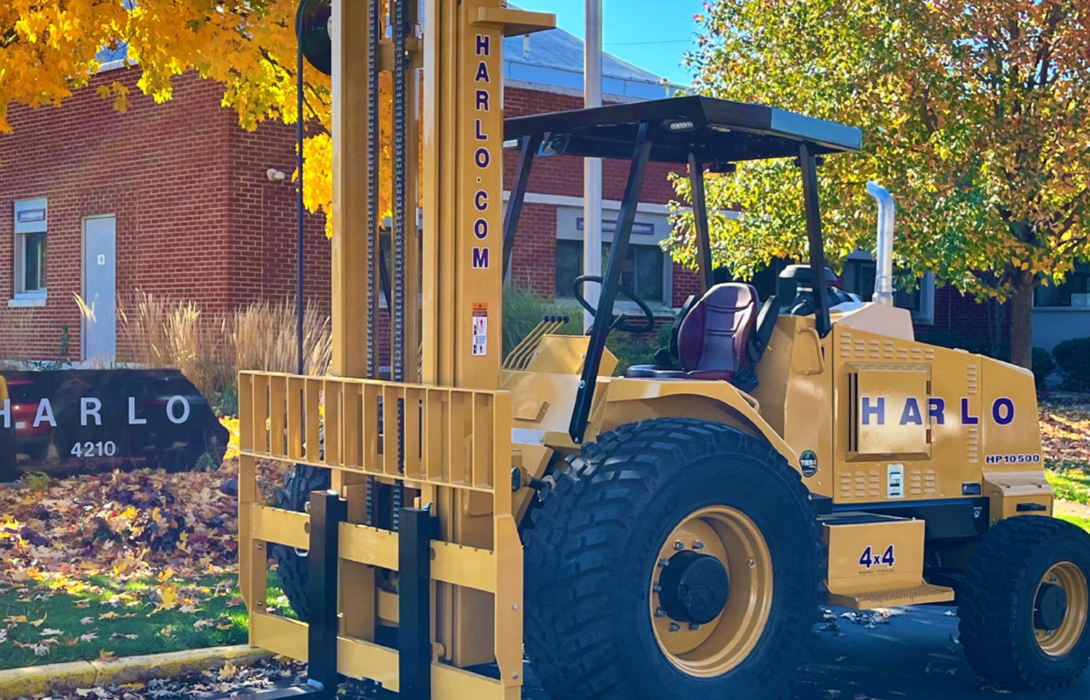 Harlo 4x4 rough terrain forklift parked outside the Harlo headquarters building